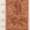 The Pirate Tarot’s engraved wooden Fool card shows a cheerful pirate raising a mug on a ship’s plank. Waves, clouds, a bird, and keywords—Ambiguity, Chaos, Faith, Luck—add to this playful scene from the Pirate Tarot deck.