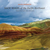 Book cover of 'Back Roads of the Pacific Northwest' with colorful hills and clouds.