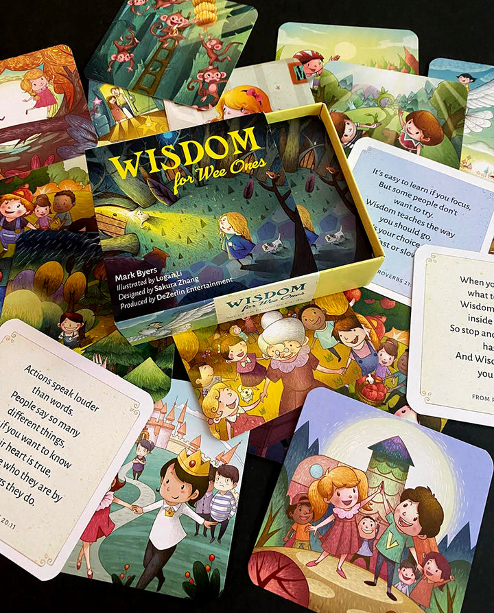 A vibrant Wisdom for Wee Ones box by Schiffer Publishing, Ltd. sits open, surrounded by Proverbs cards with cheerful kids and animals, plus cards featuring uplifting quotes.