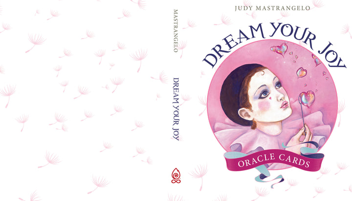 Book cover for Dream Your Joy Oracle Cards by Schiffer Publishing, Ltd., featuring a dreamy child in purple blowing dandelion seeds and pink hearts—perfect for meditation and unique affirmations.