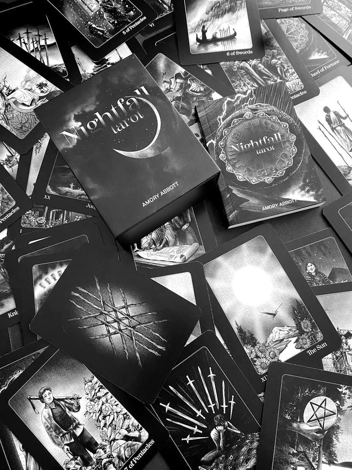 A black and white image displays the Nightfall Tarot by Schiffer Publishing, Ltd., featuring its deck box surrounded by all 78 uniquely illustrated cards arranged in a scattered Rider-Waite-Smith-inspired pattern.