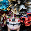 A person with a colorful Día de los Muertos skull face paint and vibrant paper flower crown, featured in "San Miguel de Allende" by Schiffer Publishing, Ltd.—a photo book celebrating this lively UNESCO World Heritage Site.