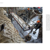 In Schiffer Publishing, Ltd.’s "Restoring Notre-Dame de Paris," three workers in helmets and harnesses scale a rugged stone wall amid restoration, surrounded by scaffolding and tools—a scene evocative of Patrick Zachmann’s photography.