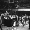 A black-and-white photo featured in "Teenage Wasteland" by Schiffer Publishing, Ltd. captures a litter-strewn indoor arena after The Who's Winterland show, with people lingering near equipment marked "The Who.