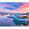 A fishing boat with lobster traps rests on calm water at sunset, surrounded by boats and a quaint harbor town—an iconic scene from "Back Roads of Maine" by Schiffer Publishing, Ltd., perfect for landscape photography enthusiasts.