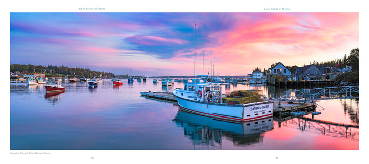 A fishing boat with lobster traps rests on calm water at sunset, surrounded by boats and a quaint harbor town—an iconic scene from "Back Roads of Maine" by Schiffer Publishing, Ltd., perfect for landscape photography enthusiasts.