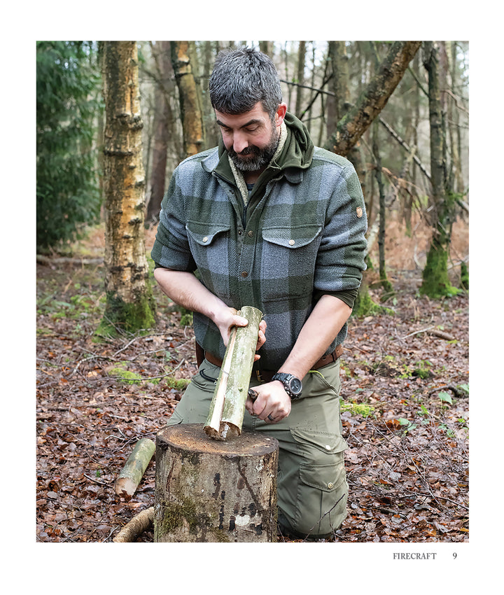 A man in green plaid kneels in a forest, splitting a log on a stump with a knife—practicing bushcraft skills just like those taught in "Core Bushcraft" by Schiffer Publishing, Ltd., for the authentic outdoor survival experience.