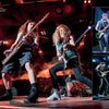 Two rock guitarists perform energetically onstage under colorful lights. To the right, three smaller images show a third guitarist, capturing the energy of "Hallowed by Their Name" from Schiffer Publishing, Ltd., reminiscent of Iron Maiden.