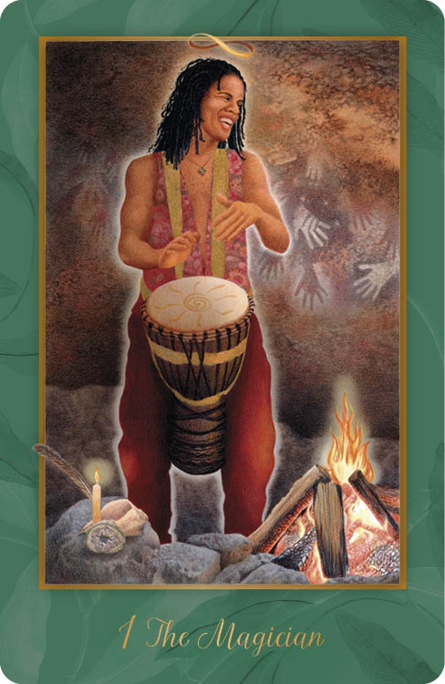 A joyful person with dreadlocks drums by a campfire, surrounded by rocks, a candle, and a feather. Faint handprints mark the wall behind. The card is 1 The Magician from Gaian Tarot by Schiffer Publishing, Ltd., honoring earth spirit.