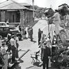 A black-and-white photo on the cover of "The Art of Classic Crime and Mystery Movies" by Schiffer Publishing, Ltd. shows a busy film crew with actors, vintage cars, and equipment outside the Santa Rosa train station.