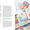 The Creative Sketchbook Magic by Schiffer Publishing, Ltd. features colorful watercolor bird and landscape art alongside paints and brushes—perfect for beginner art lessons or daily prompts on a bright white surface.