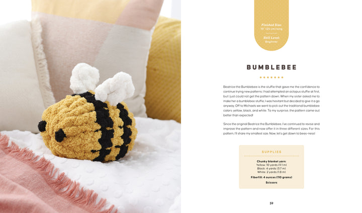 A chunky yarn, yellow and black bumblebee toy with white wings rests on a textured pink and white blanket, surrounded by pillows. On the right are text instructions and supplies from "Get Started in Finger Knitting" by Schiffer Publishing, Ltd.