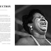 A Black woman sings passionately into a microphone on stage in this vibrant blues photo from "Inside the Moment" by Schiffer Publishing, Ltd. The left side features an introduction by Joseph A. Rosen.