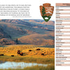 Bison graze in a sunlit valley with mountains behind. An overlay features Schiffer Publishing, Ltd.'s The Complete Guide to America's National Parks, a quote, and a checklist of major U.S. national park locations.