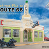 Route 66 cafe with a motorcycle parked in front, under a blue sky.