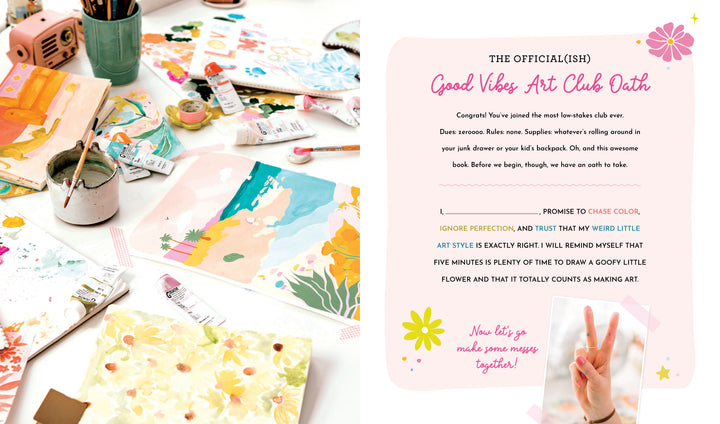 A vibrant workspace with paints, brushes, and drawings sits by Schiffer Publishing's Good Vibes Art Club Learn to Draw, whose cheerful oath encourages embracing color, having fun, and enjoying modern art—not perfection—in every creative project.