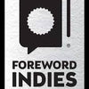 A rectangular silver badge with a black book and seal icon above the bold text "Foreword INDIES WINNER"—a perfect keepsake for fans of Crochet Girls by Schiffer Publishing, Ltd.
