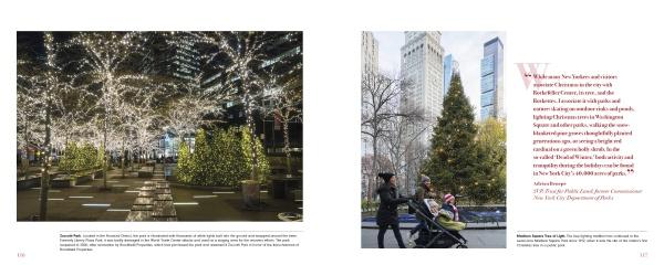 A city park sparkles with holiday lights and festive trees as a person with a stroller passes a towering Christmas tree, skyscrapers in the background—featured in ’Tis the Season New York by Schiffer Publishing, Ltd.