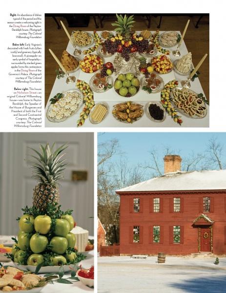 A lavish table of fruits, nuts, and desserts with stacked apples and pineapple is displayed above a red colonial house in snow, as featured in "Christmas at Historic Houses" by Schiffer Publishing, Ltd.