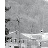 At the United States Military Academy, a building rises amid trees—setting for ghostly tales explored in "Fright to the Point: Ghosts of West Point" by Schiffer Publishing, Ltd., where haunted legends linger across generations.