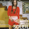 A woman with long brown hair wearing a red crop top and shorts stands by a piano, pulling down her shorts to reveal star-patterned underwear. Large text reads The Worst of While You Were Sleeping by Schiffer Publishing, Ltd., echoing a pop culture book cover.