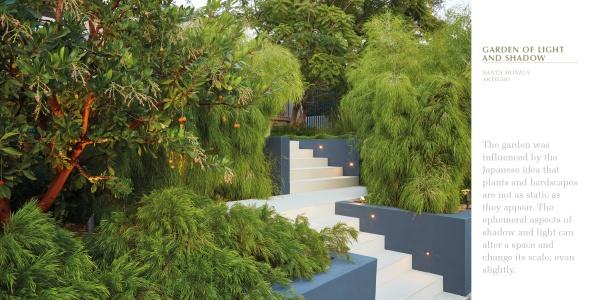 Wide white steps with built-in lights wind through lush Southern California foliage. Framed by clean blue-grey walls, this modern garden design is featured in "Regional Landscape Architecture: Southern California" by Schiffer Publishing, Ltd.