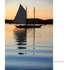 A sailboat glides on calm water against a sunset in "Maine" by Schiffer Publishing, Ltd., capturing the serene reflections and scenic beauty of classic Maine landscapes.