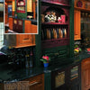 Great Kitchens by Schiffer Publishing, Ltd. showcases luxurious kitchen designs with dark green and wood cabinetry, black countertops, decorative plates, floral accents, and custom storage solutions for an elegant look.