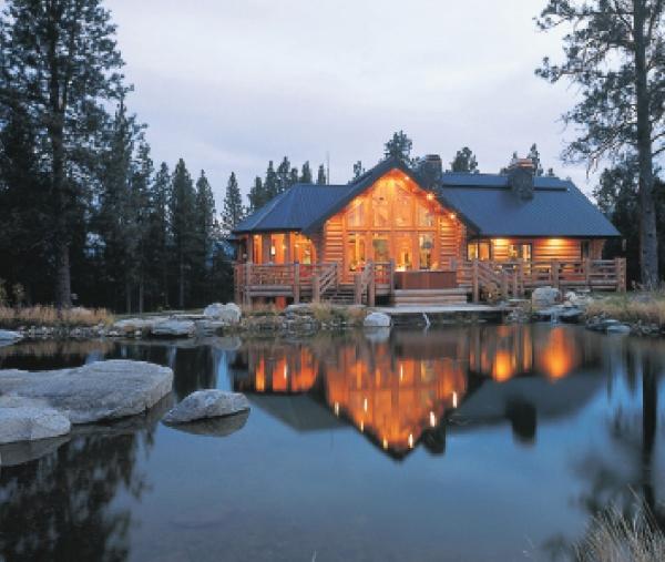 “The Best of Today’s Log Homes” by Schiffer Publishing, Ltd. features classic log home designs, including scenic log cabins set against serene lake backdrops.