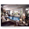 Entertainment Rooms by Schiffer Publishing, Ltd. showcases bright indoor pool rooms with large windows, lush plants, lounge chairs, and a stylish home bar for a relaxing, sunlit leisure space.
