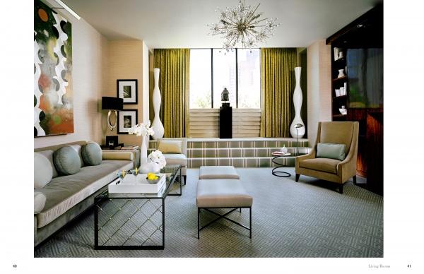 Modern living room inspired by Showhouses 2 from Schiffer Publishing, Ltd., featuring a beige sofa, two ottomans, glass coffee table, abstract painting, tall white vases, armchair, geometric chandelier, and green curtains.