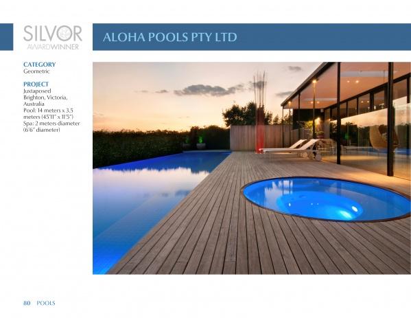 At sunset, a modern backyard features a rectangular pool and circular spa on a wooden deck by a glass-walled house, as seen in Schiffer Publishing, Ltd.'s "International Award Winning Pools, Spas, and Water Environments IV.
