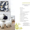 A room features a white fireplace, gold and black abstract art above, and handcrafted sheep sculptures. On the right, a contents page from "Celebrating MacKenzie-Childs" by Schiffer Publishing, Ltd. is displayed.