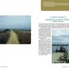 A sandy path through grassy dunes leads to the ocean under clouds, while a Bike Ferry sign sits on the dock—classic Martha’s Vineyard scenery from "In My Footsteps" by Schiffer Publishing, Ltd.