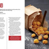 Crisp French Fries spill from an open brown paper bag onto a black surface with a fork and dipping sauce, featured with a Schiffer Publishing, Ltd. potato cookbook recipe and preparation instructions.