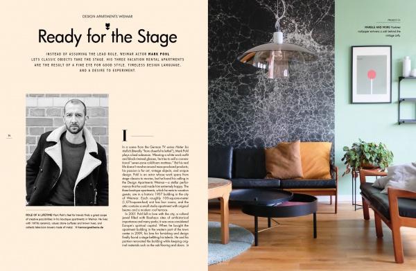 A spread from "Home Story" by Schiffer Publishing, Ltd. features a left page with text and a black-and-white photo of a man in a coat, and a right page showcasing German interior design with marble walls, green accents, and wooden furniture.