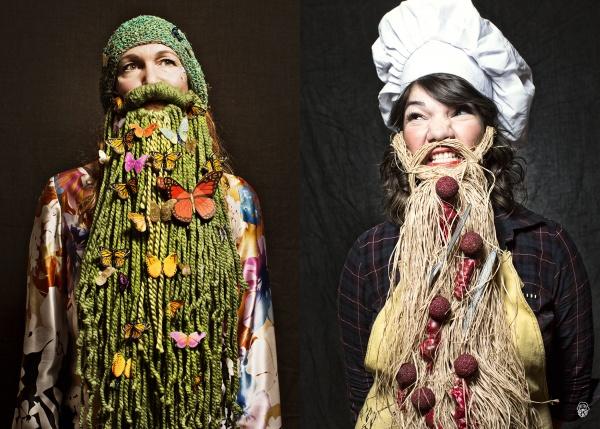 Two women display their competitive bearding skills—one wears a green yarn beard with butterflies and flowers, the other a straw beard with red balls and a chef’s hat—celebrating creative pogonotrophy with Art of the Beard by Schiffer Publishing, Ltd.