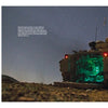 A Schiffer Publishing, Ltd. M2/M3 Bradley infantry fighting vehicle with an open rear ramp glows green inside, parked outdoors at night under a starry sky. An inset displays a close-up of its exterior side panel and markings.