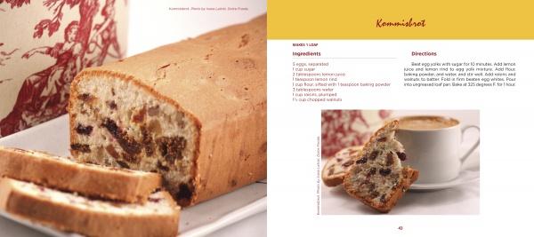 A loaf of fruit-filled bread, inspired by traditional Serbian recipes from "Serbian Cooking" by Schiffer Publishing, Ltd., is sliced on a plate beside a decorative container, while slices are served with coffee and a Kommisbrood recipe.