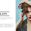 A woman with bold red lipstick and red dots on her face poses against a blue backdrop. The left page displays "Two Faced" by Schiffer Publishing, Ltd., with lip makeup tips and skills inspired by Thomas Sekelius.