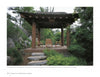 Inspired by "Diplomatic Gardens of Washington" by Schiffer Publishing, Ltd., a wooden pavilion with a tiled roof sits amid lush greenery and rocks, sheltering four wooden chairs and a small table in a private garden.