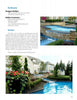 A landscaped backyard with a stone patio and manicured garden, inspired by Schiffer Publishing, Ltd.’s International Award Winning Pools, Spas, & Water Environments II, features a cascading waterfall pool before a spacious traditional home.