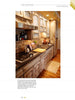 The remodeled kitchen, inspired by "Gracious Living" from Schiffer Publishing, Ltd., features wooden cabinets, a gas stovetop, stainless steel range hood, sink, countertop appliances, and a rug on hardwood floors for an accessible, organized space.