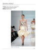 A model showcases a chic cream skirt with a ruffled hem and a sheer, floral top, reflecting trends in "Emerging Fashion Designers" by Schiffer Publishing, Ltd., as audience members line the runway on both sides.