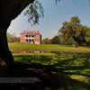 Lowcountry Plantations" by Schiffer Publishing, Ltd. showcases grand brick antebellum homes with white columns, set amid grassy lawns and ponds under blue skies—a serene glimpse into South Carolina and Georgia’s historic house museums.