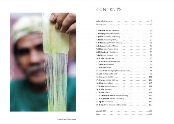 A man stretches a thin, translucent sheet in the foreground while the blurred table of contents from "Threads Around the World" by Schiffer Publishing, Ltd. is visible on the right.