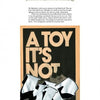 A page titled KOLORSTORM from Schiffer Publishing, Ltd. showcases a poster with bold "A TOY ITS NOT" text above NYC graffiti-inspired letters, plus a paragraph about the artist’s approach to illustration.