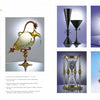 A magazine spread showcases Schiffer Publishing, Ltd.'s "Glass Art," featuring Cesare Toffolo’s portrait, six vibrant glass sculptures and vessels, plus text highlighting Toffolo’s biography and role among leading glass artists.