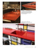 Two photos from "The Countertop Book" by Schiffer Publishing, Ltd. show modern kitchens with bold red countertops—one with a sleek glossy island, the other pairing a red surface and sink with Mondrian-style cabinetry.
