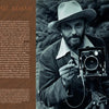 A bearded man in a hat and jacket holds a large vintage camera outdoors. Text beside him introduces "Yosemite National Park: Past and Present" by Schiffer Publishing, Ltd., highlighting Ansel Adams’ iconic Yosemite photos.